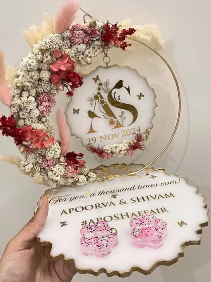 A stunning ring platter with a floral hoop in shades of red, pink, and white. The custom hashtag '#APOSHAffair' makes it truly personal.