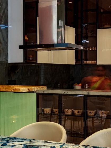 The kitchen includes a breakfast counter with a unique live-edge wooden top, creating a perfect spot for casual family meals.