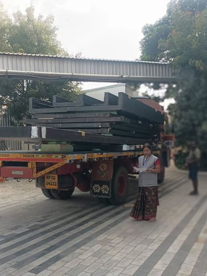 A truck delivering the finished composite panels to the construction site. This prefabrication method minimizes on-site waste and significantly speeds up the project timeline, with this project nearing completion in just 8 months.