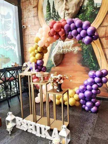 Another colorful take on the balloon arch, this time with a rainbow gradient of purple, yellow, and pink for a vibrant 21st birthday party.