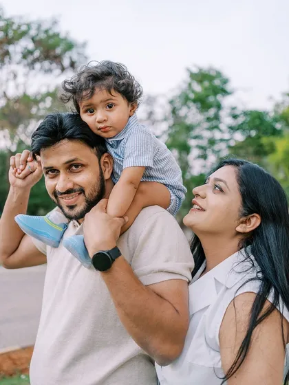 A family portrait with the father holding his son on his shoulders. A classic, fun pose that always brings out smiles.