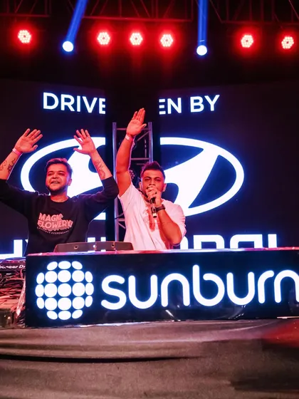 Hyping the crowd alongside a partner at a Hyundai sponsored Sunburn event. Corporate events require a professional yet high-energy approach.