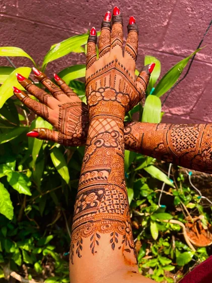 A beautiful back-of-hand design with a fresh, dark henna application. The rich paste ensures a deep and lasting stain for the wedding festivities.