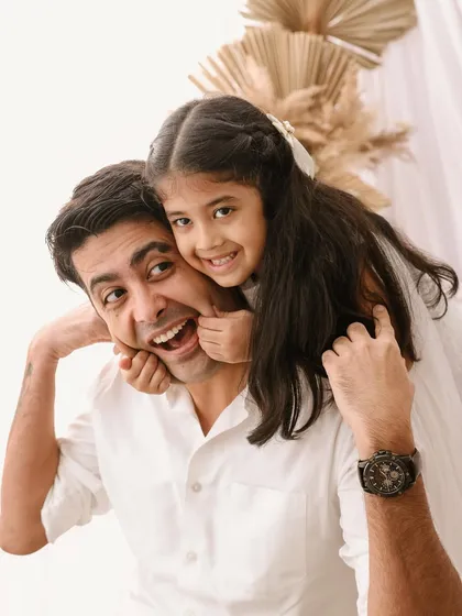 A father's playful love. This candid shot of a dad and his daughter sharing a silly moment is what family photography is all about. It's about capturing the real relationship and the joy you share.