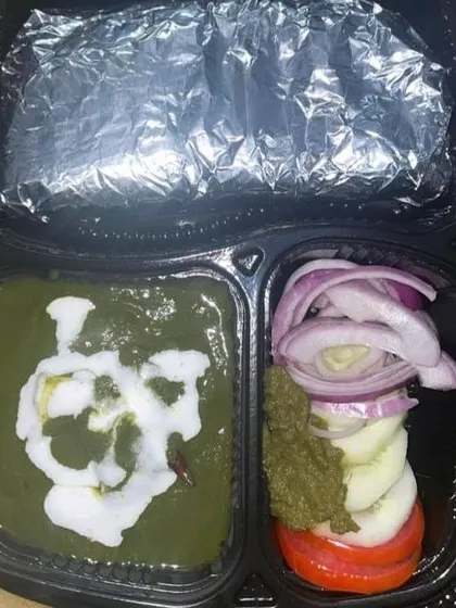 Enjoy a classic North Indian favorite with my Palak Paneer tiffin. The fresh spinach gravy is paired with soft paneer cubes and served with hot rotis and salad for a nutritious meal.