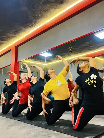 A beautiful group backbend, with students moving in unison to open their hearts and shoulders.