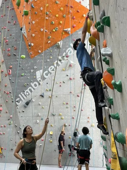 A belayer pays out rope for her climber, demonstrating the teamwork that is central to the sport.