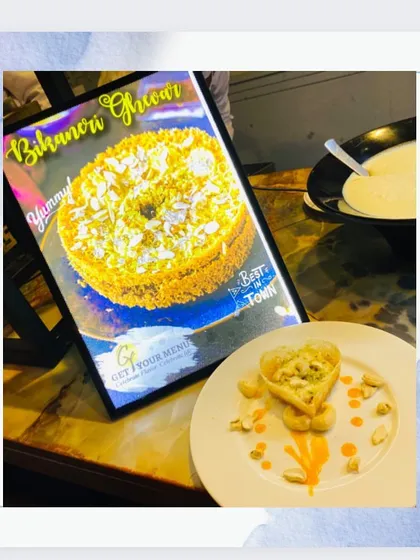 Our Bikaneri Ghewar station, complete with a digital menu and an artfully plated heart-shaped ghewar.