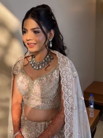 This candid shot captures the beautiful details of her sangeet makeup, with a strong contour and a shimmery, silver-toned eyeshadow.