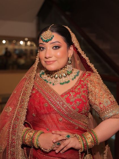 A full bridal look featuring a red lehenga with green-accented kundan jewellery. These images show how you can create a perfectly coordinated and stunning bridal look through my rental service.