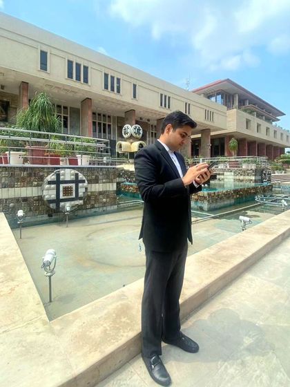 Taking a moment between hearings outside a Delhi court complex. The environment is demanding, and I am always connected and prepared for the next step.