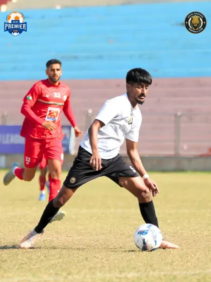 A player maintains possession under pressure, looking for an opening.