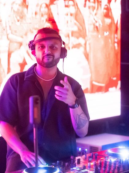 A close-up shot from the elevated booth, pointing at the crowd below. It's all about that connection.