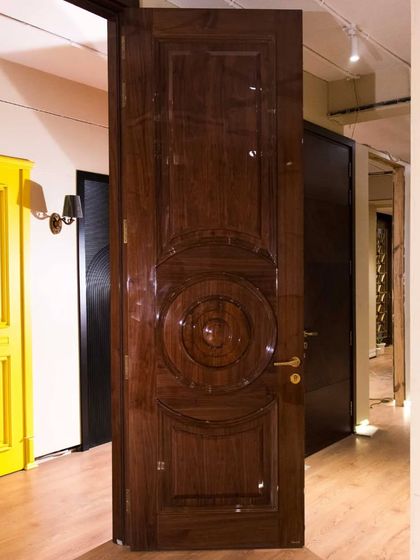 A full view of a solid wood door with an engineered panel, finished in a stunning high-gloss polish. This door stands as a testament to classic design and luxurious finishing.