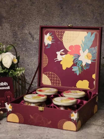 A rich burgundy box with floral motifs, perfect for premium dry fruits. The details on the packaging make all the difference.
