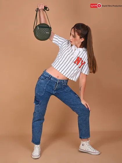 A stylized pose for a small crossbody bag, shot against a colored background. We use different backdrops to match your brand's aesthetic and make your products pop.