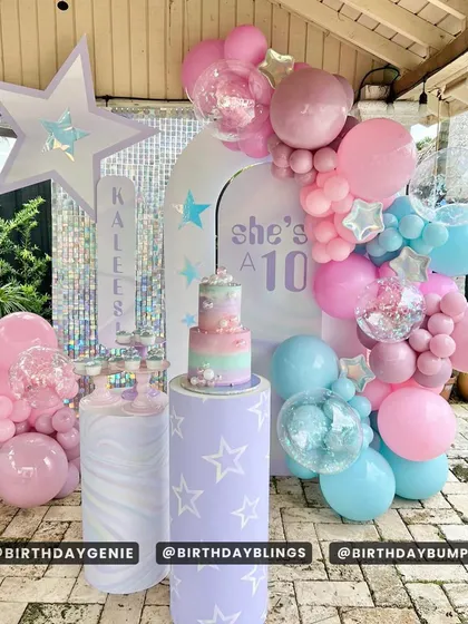 A dreamy "She's a 10" birthday party with a celestial theme. The pastel pink, blue, and purple balloons, along with star-shaped props and confetti balloons, create a magical galaxy.