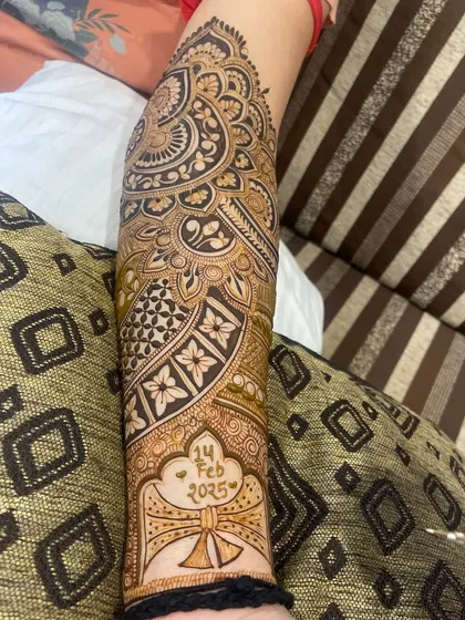 The completed arm design with the wedding date "14 FEB 2025" prominently displayed.