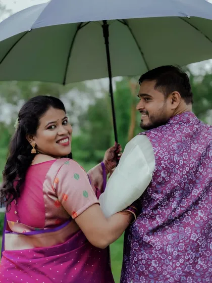 A playful shot of Milind and Anushree under an umbrella during their monsoon engagement shoot. It shows their fun-loving personalities.