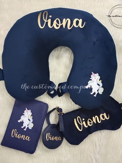 Have a holiday around the corner? This unicorn-themed travel set is a must-have. It includes a personalized neck pillow, eye mask, passport cover, and bag charm in a deep navy blue.