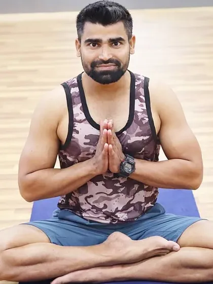 Seated with hands in Namaskar Mudra. This gesture represents gratitude and the belief that the divine in me honors the divine in you, a core principle of my teaching philosophy.