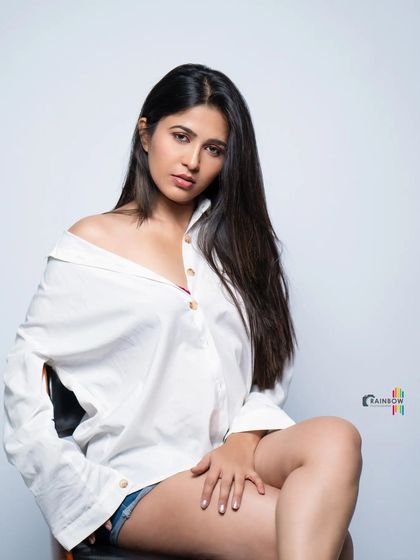 A full-body shot of the white shirt and shorts look, creating a casual yet stylish studio portrait.