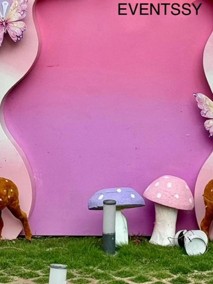 A close-up of the whimsical props, including deer figures and colorful mushrooms, that add detail to the fairy theme.