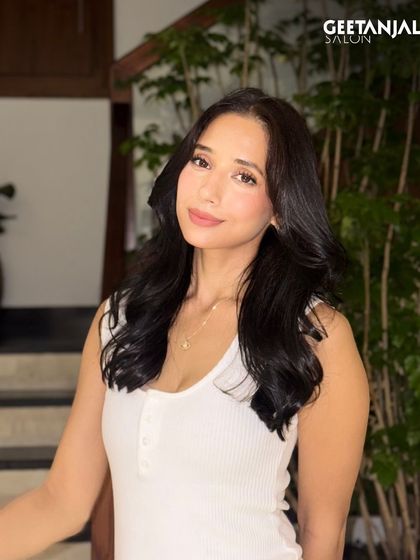 A portrait shot showcasing the rich, deep black colour and healthy, voluminous hair.