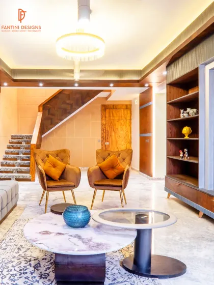 From this angle, you can see the flow from the seating area to the staircase. We used consistent materials and lighting to ensure the entire space feels connected and harmonious.