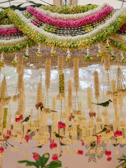 A detailed shot of the dense floral garlands, or 'thoranams', that formed the entrance to the mandap. The mix of white, green, and pink flowers created a rich and festive texture.