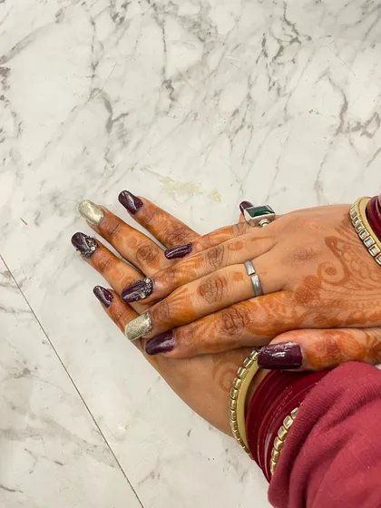 A beautiful example of festive nail art created in our salon. This design combines a deep wine color with sparkling gold accents, a popular choice for weddings and special occasions.