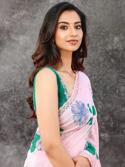 A duplicate of image 5, this image shows a classic portrait pose in a vibrant floral saree, representing a fresh and modern approach to ethnic fashion styling.