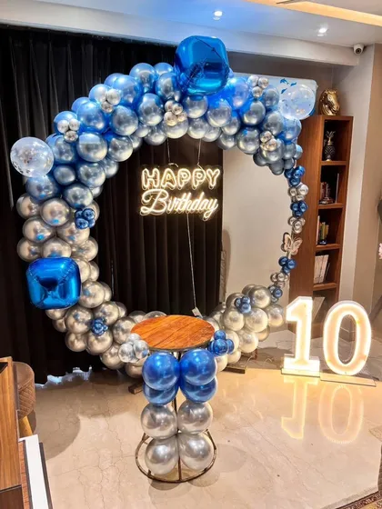 A centered shot of the 10th birthday balloon ring with a small cake table.