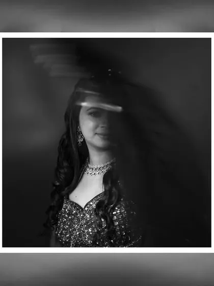 An abstract black and white portrait of the bride. The motion blur effect adds a dynamic and artistic layer to this engagement photo.