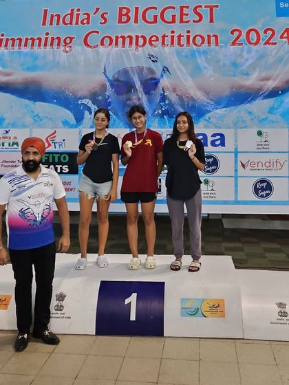 The podium for a historic race. Prapti Ghose (center) after setting a new record for the fastest swim in Haryana's history, a proud moment for the entire Ace Aquatic Academy.