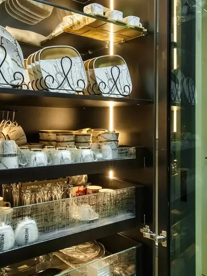 A close-up of the beautifully organized crockery unit at our Lodha Park project. Glass shelves and internal lighting create a stunning display.