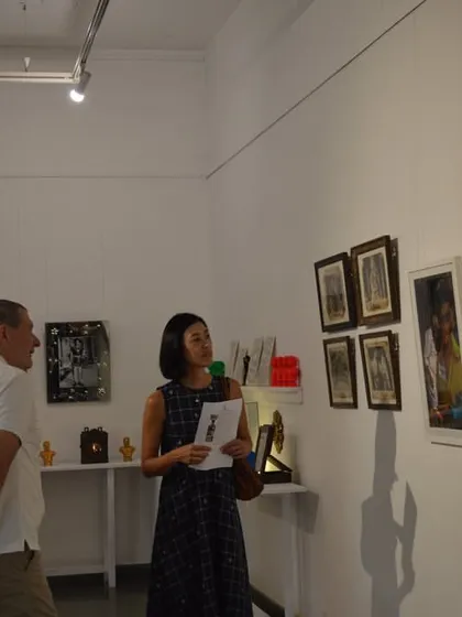 The Consul General and his wife viewing the collection of framed photographs and prints.