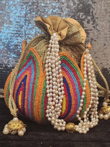 It's not just about jewellery. I also find beautiful accessories like this vibrant, handcrafted potli bag. The intricate, multi-color beadwork and pearl handle make it the perfect companion for your festive outfits.