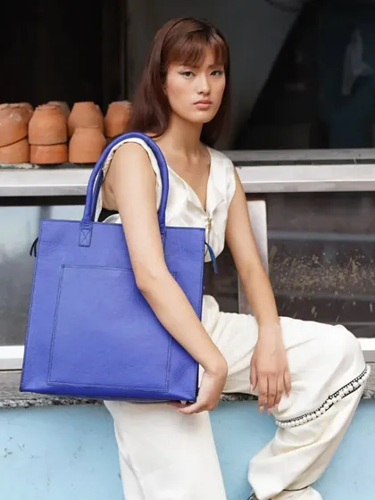 The Box Tote in a stunning Parisian Blue. This bag is a true embodiment of style, sophistication, and practicality, crafted to perfection.