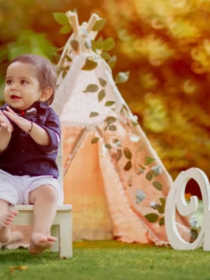 Capturing childhood magic in nature’s embrace. This little one is clapping for his first birthday.