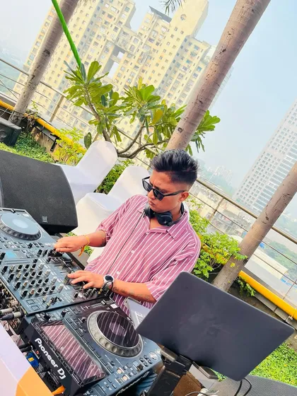 At the console, mixing tracks for another rooftop event. I believe that music is the strongest form of magic, and I try to create that magic at every gig.
