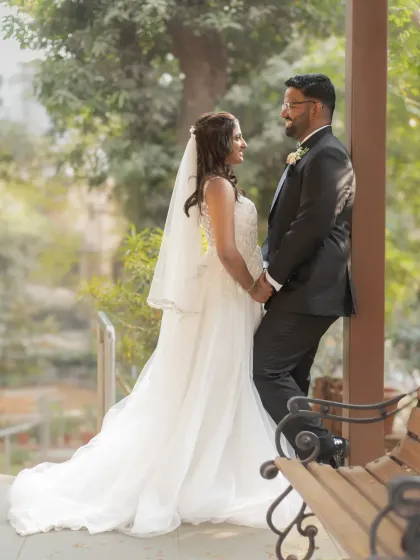 A romantic portrait of the couple enjoying a quiet moment together. The beautiful outdoor setting and their loving gaze make this a timeless wedding photograph.