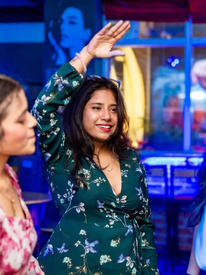 A guest with her hand in the air, fully immersed in the party. This is the kind of energy I strive for every night.