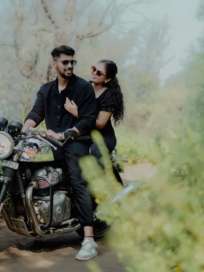 A stylish couple poses with a motorcycle during their pre-wedding shoot, perfect for those who want to add a bit of edge to their photos.
