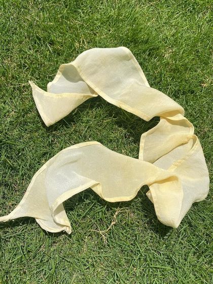 A versatile hair ribbon, perfect for tying up a ponytail or weaving into a braid. The soft yellow colour comes from onion skins.