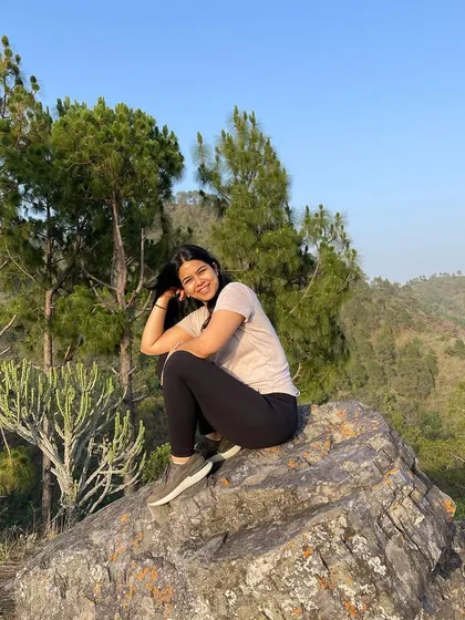 A quiet moment of reflection on a rock, surrounded by the calm of the forest. Nature is our greatest teacher, and I incorporate its lessons into every retreat.