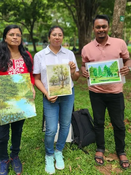 With fellow artists after a live painting session in the park, showcasing our work.