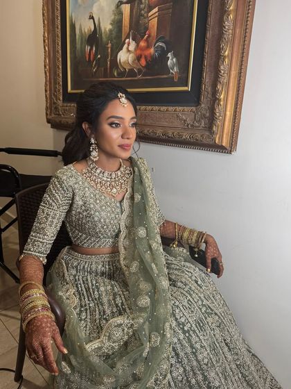 Haritha looking poised and elegant in her reception attire. Her makeup is bold and glamorous, with a strong eye look that complements her dusky skin tone.