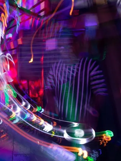 This long-exposure shot perfectly captures the motion and energy of a live DJ set. The blur of lights and movement is what a great night feels like.