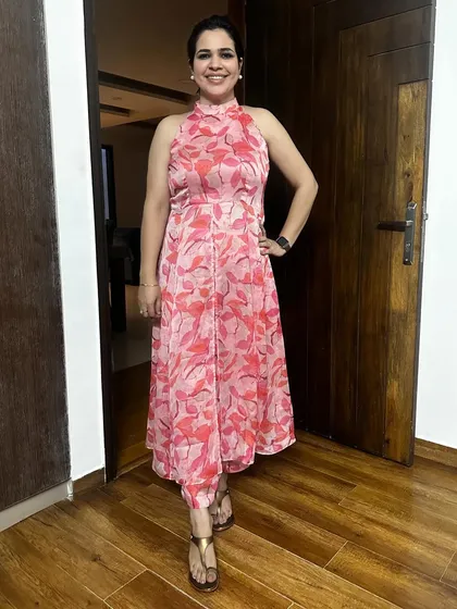 A close-up of the pink floral coord set made from a chiffon saree. The halter neck and flowy fabric make it a perfect outfit for a summer day out.